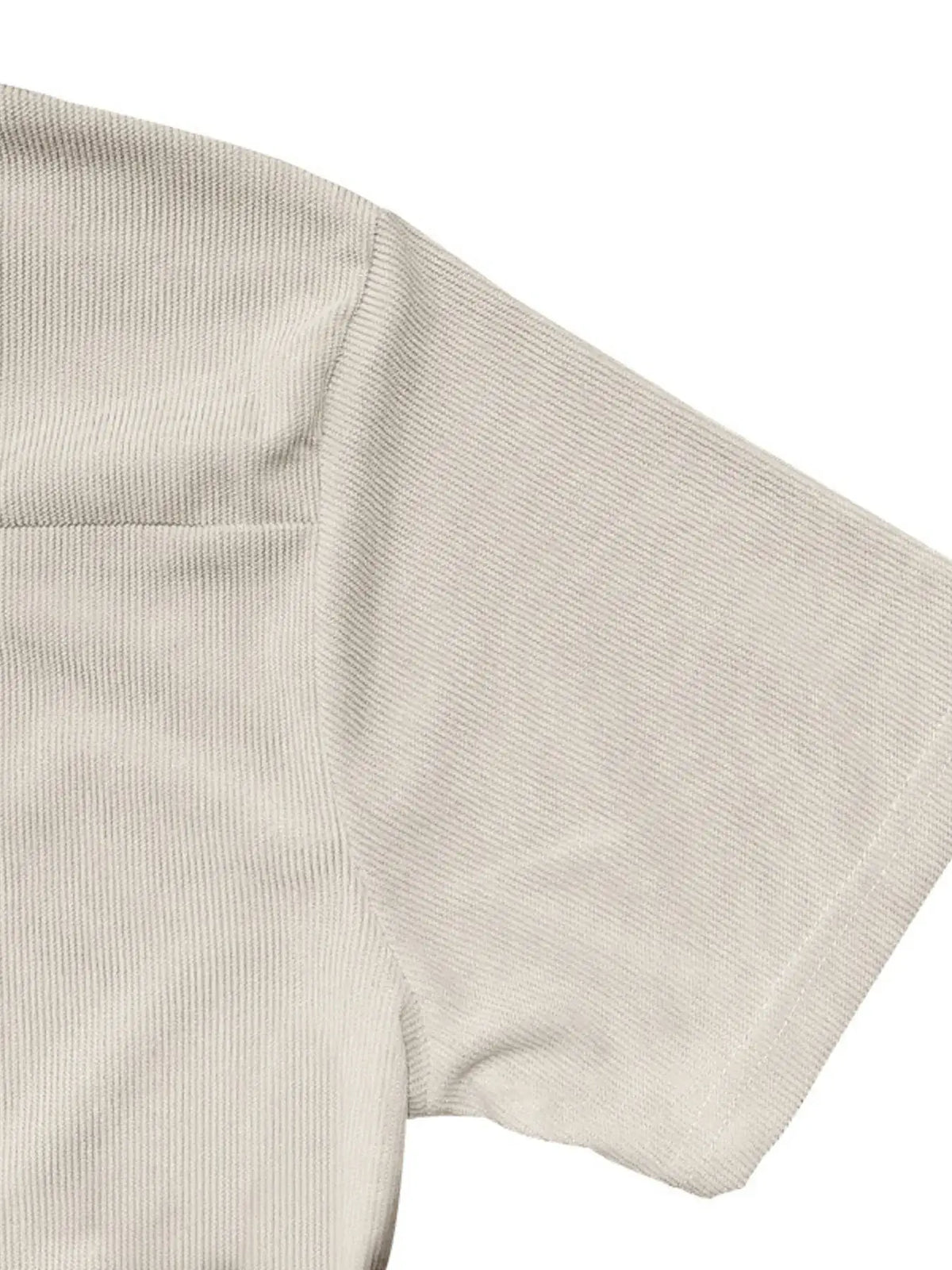 Close-up of men's short sleeve polo featuring textured fabric and pocket detail, ideal for formal wear.