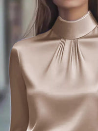 Mock Neck Long Sleeve Blouse with Pleated Detail showcasing elegant pleated design and soft fabric.