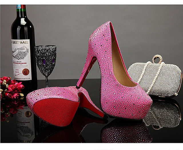 a pair of pink high heels next to a bottle of wine