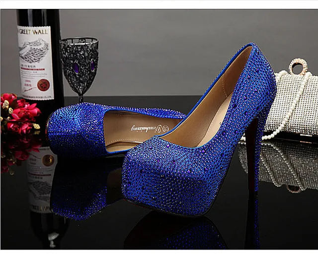 a pair of blue high heels sitting on top of a table
