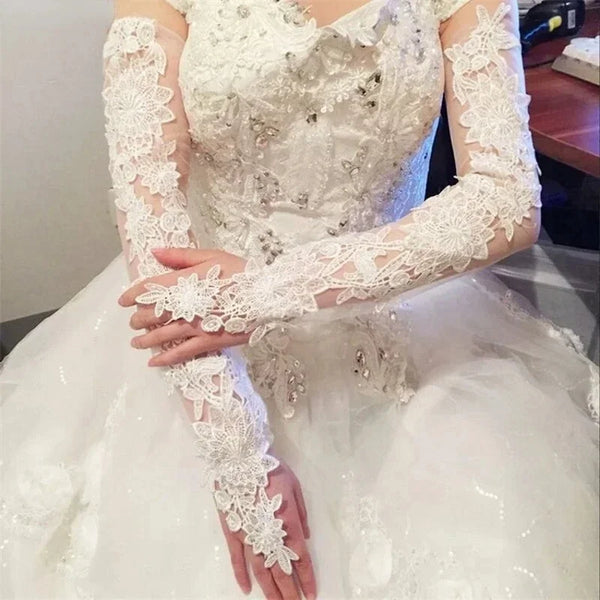 a woman in a white wedding dress wearing a white lace gloves