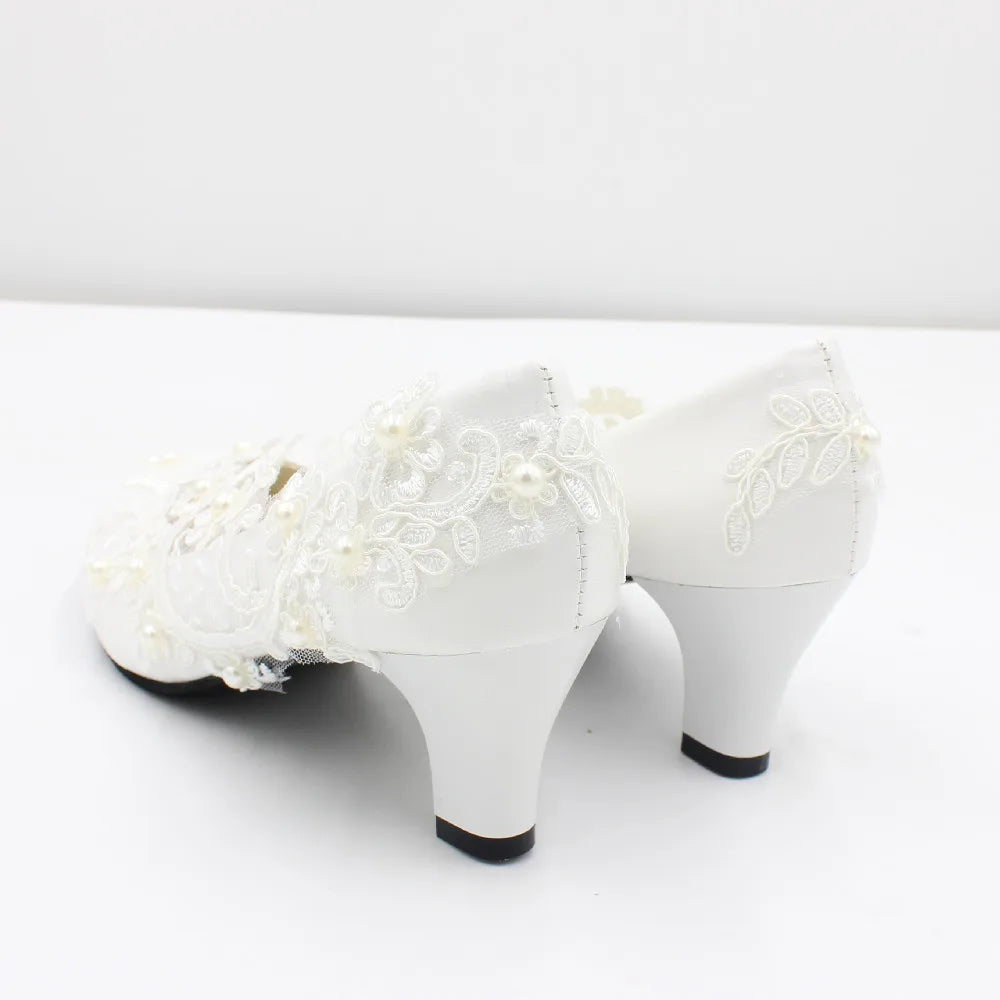 a pair of white shoes with white lace on them