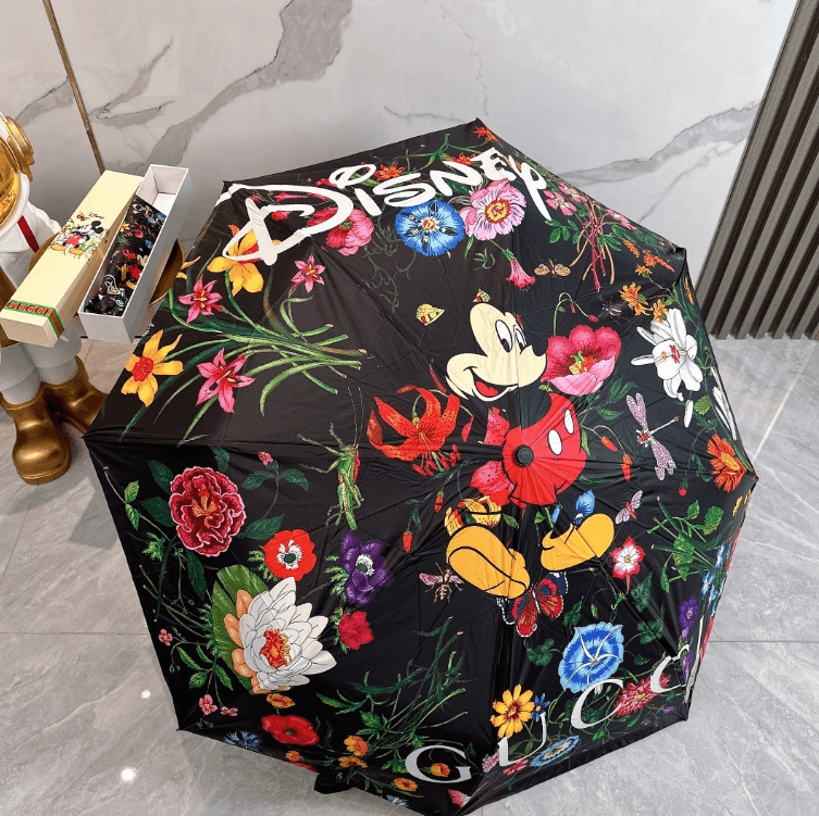 Elegant printed umbrella featuring Disney's Mickey Mouse and vibrant floral designs, perfect for any weather.