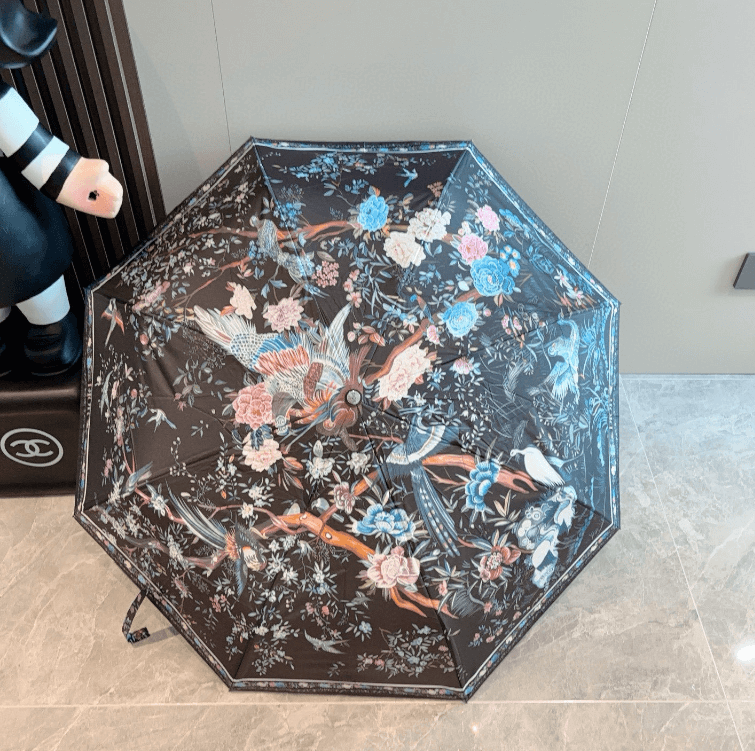 Elegant printed umbrella with floral design in vibrant colors, perfect for stylish weather protection.
