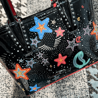 Celestial Edge handbag featuring colorful star designs and metallic studs, perfect for adding glam to any outfit.