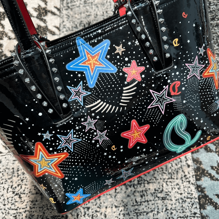 Celestial Edge handbag featuring colorful star designs and metallic studs, perfect for adding glam to any outfit.