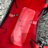 Interior view of the Celestial Edge Handbag showcasing a bright red lining and organizing features for essentials.