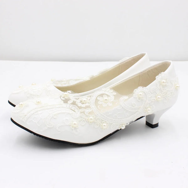 a pair of white shoes with pearls on them