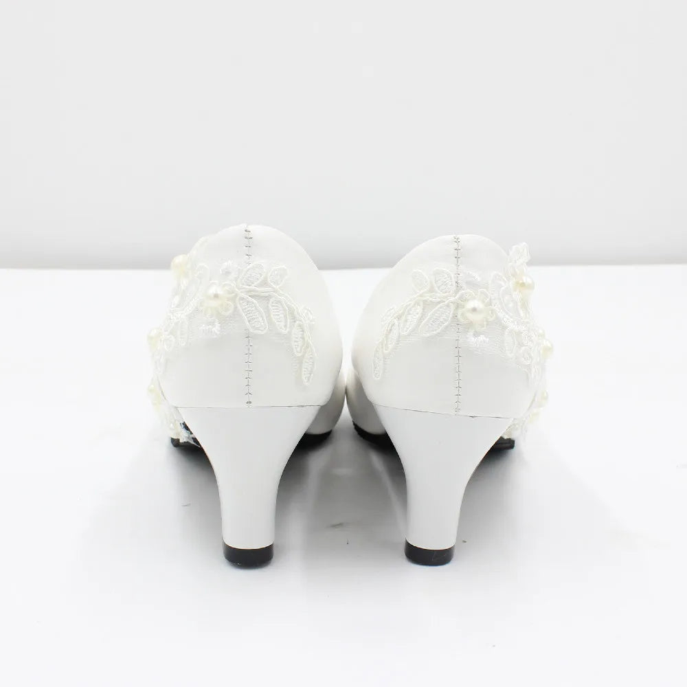 a pair of white high heels with lace