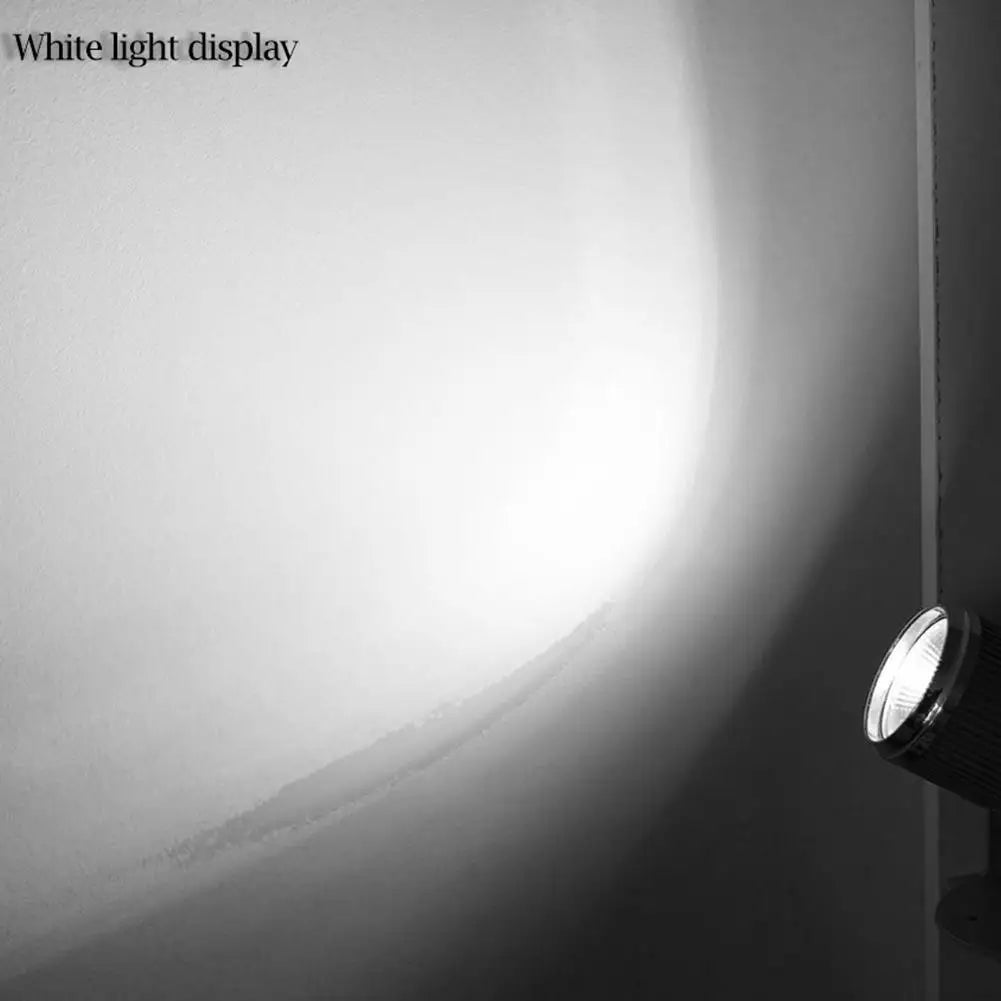 a black and white photo of a light on a wall