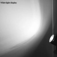a black and white photo of a light on a wall