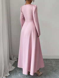 Back view of a pink square neck long sleeve maxi dress with decorative buttons and elegant silhouette.