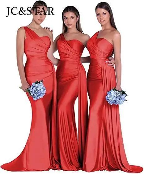 three women in red dresses standing next to each other