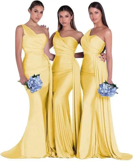 three women in yellow dresses standing next to each other