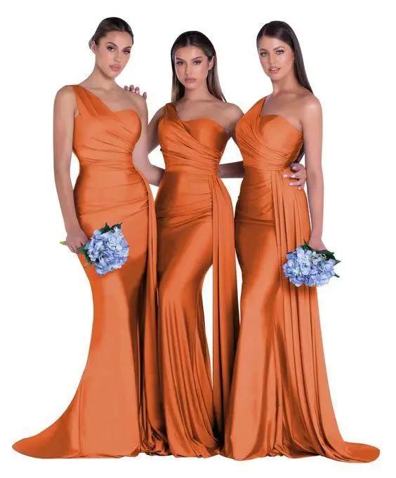 three women in orange dresses standing next to each other