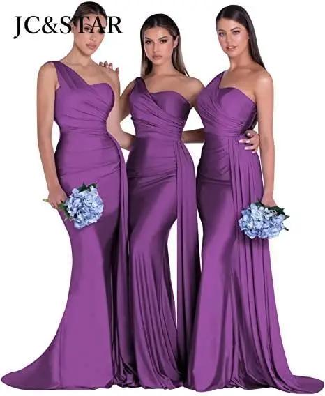 three women in purple dresses standing next to each other