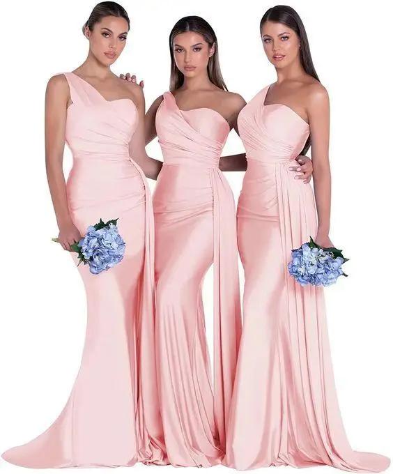three women in pink dresses standing next to each other